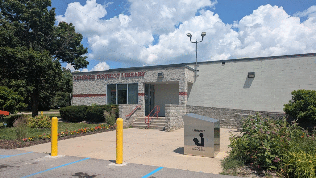 The front entrance to the William F. Delaney Headquarters Library, with a drop box in front.