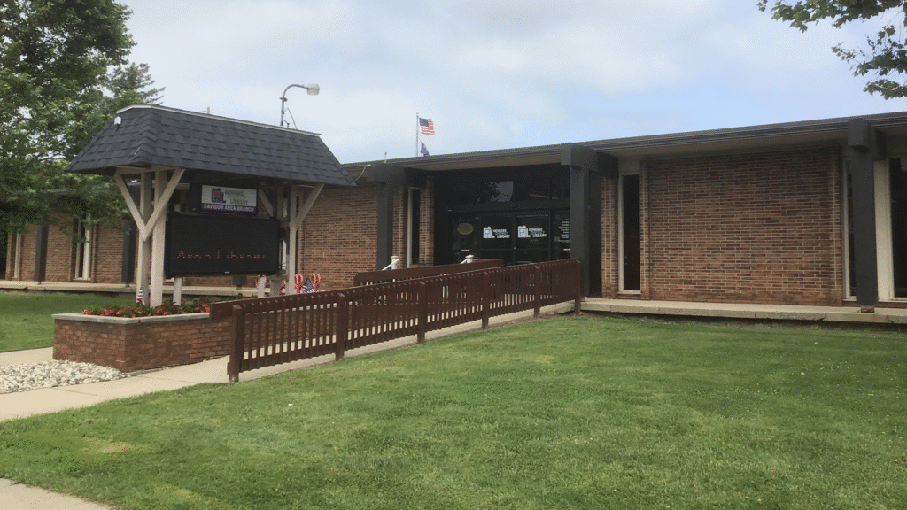 The outside of the Davison Area Library, with a wheelchair ramp in the front.