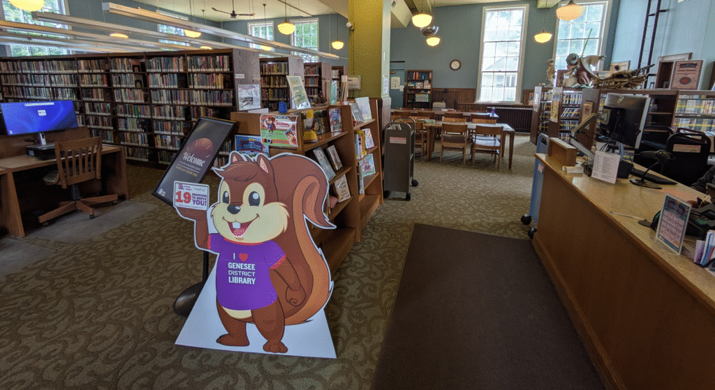 The inside of the Fenton-Winegarden Library, with computers, open tables and shelves of books