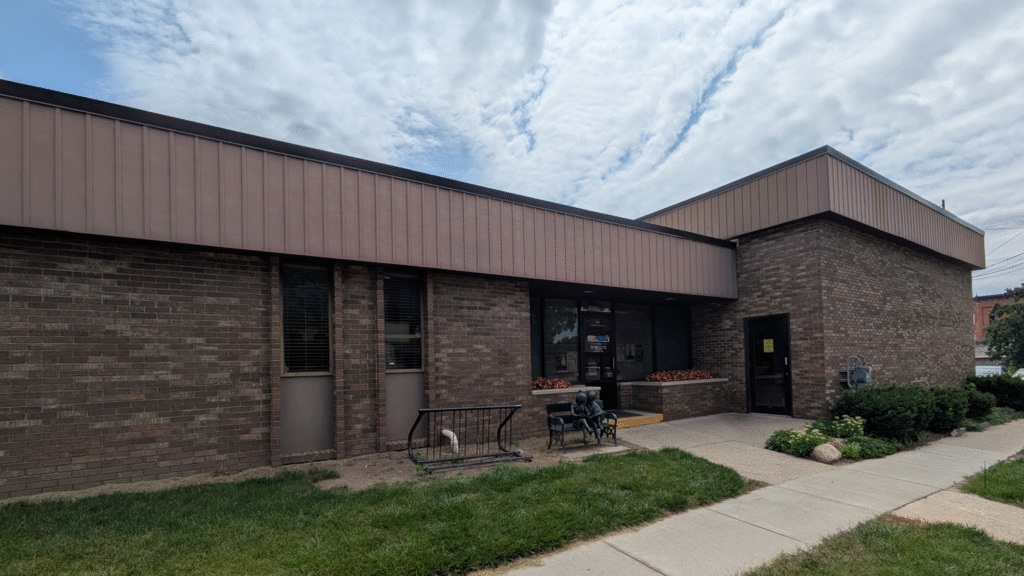 The Outside of the Flushing Area Library, with a bike rack next to the front door