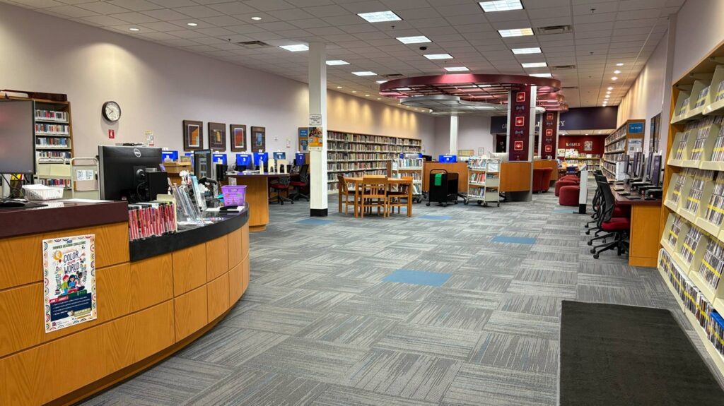 The inside of the Genesee Valley Center Library, with video games, dvds, books, and computers.