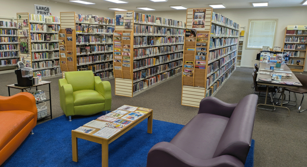The Montrose-Jennings library, with couches and chairs in a reading area, and shelves of books.