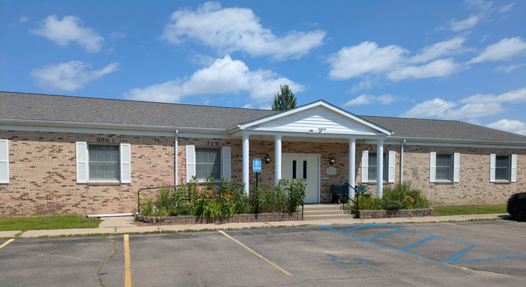 The Outside of the Montrose-Jennings Library, with stairs and a ramp at the entrance, 