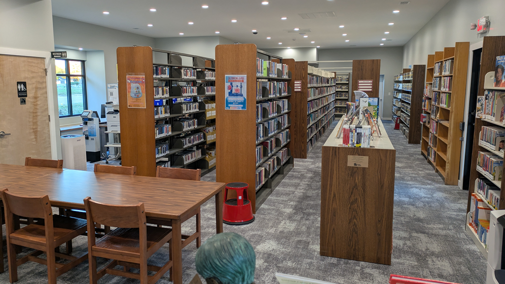 The inside of the Flushing Library, with a table for patrons to sit at.